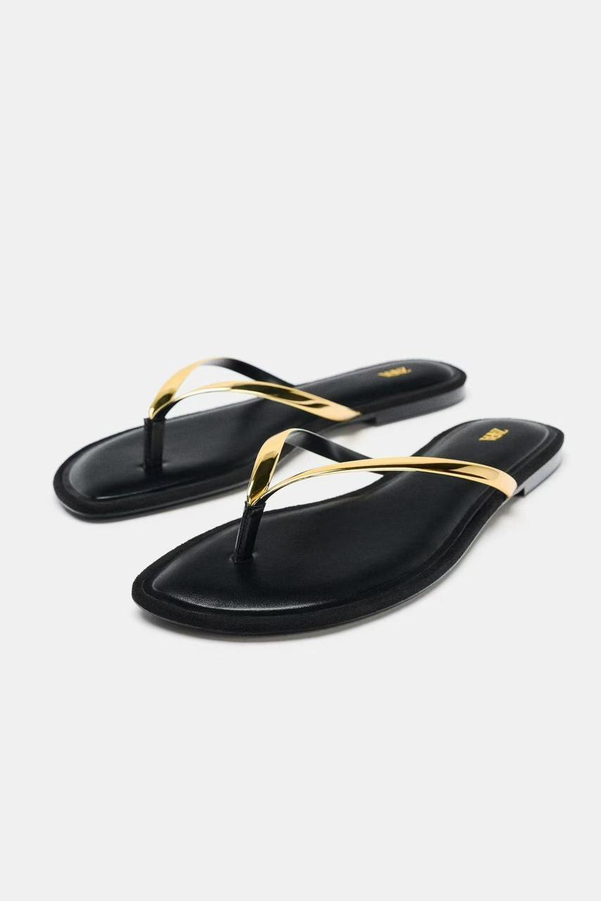 Zara black flat sandals with a metallic gold thong strap