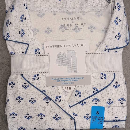 women's blue printed boyfriend pyjamas featuring a white fabric with a blue floral polka dot pattern.