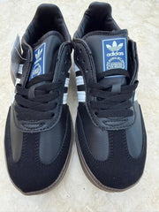 Adidas Samba OG shoes in black with a distinctive gum rubber outsole.