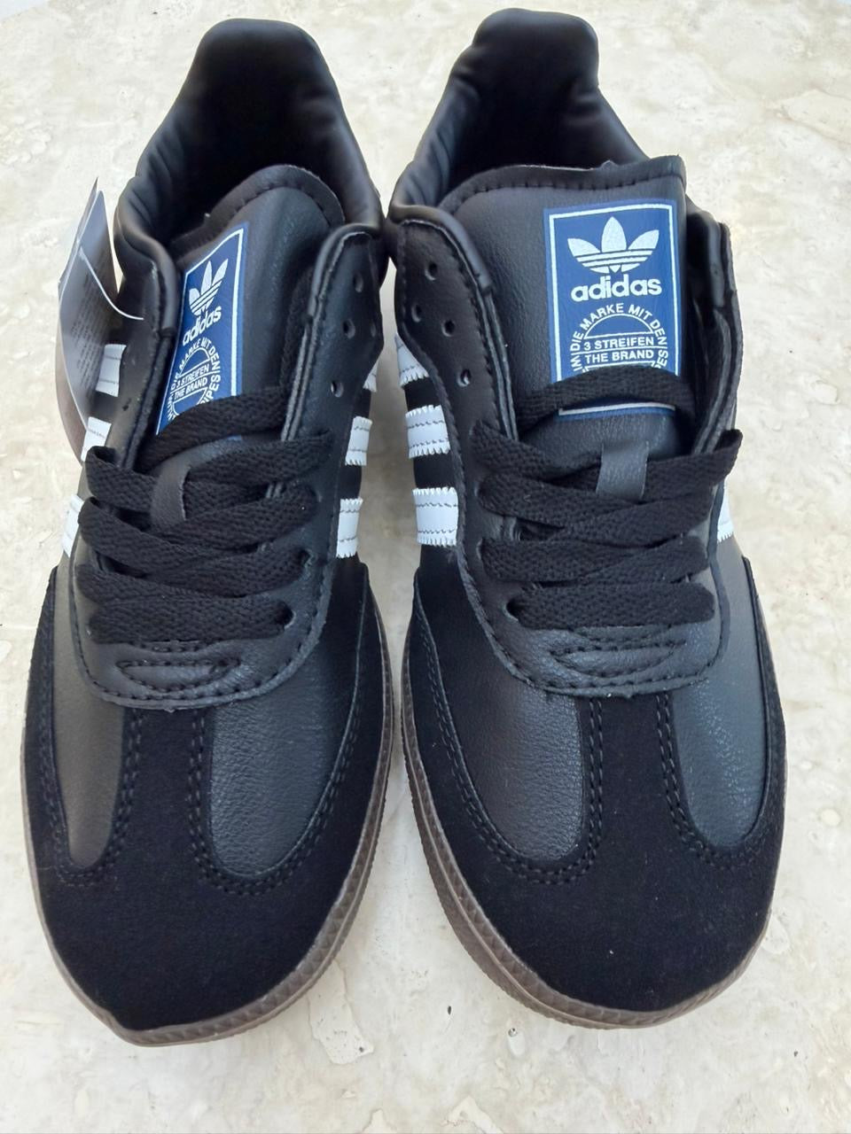 Adidas Samba OG shoes in black with a distinctive gum rubber outsole.