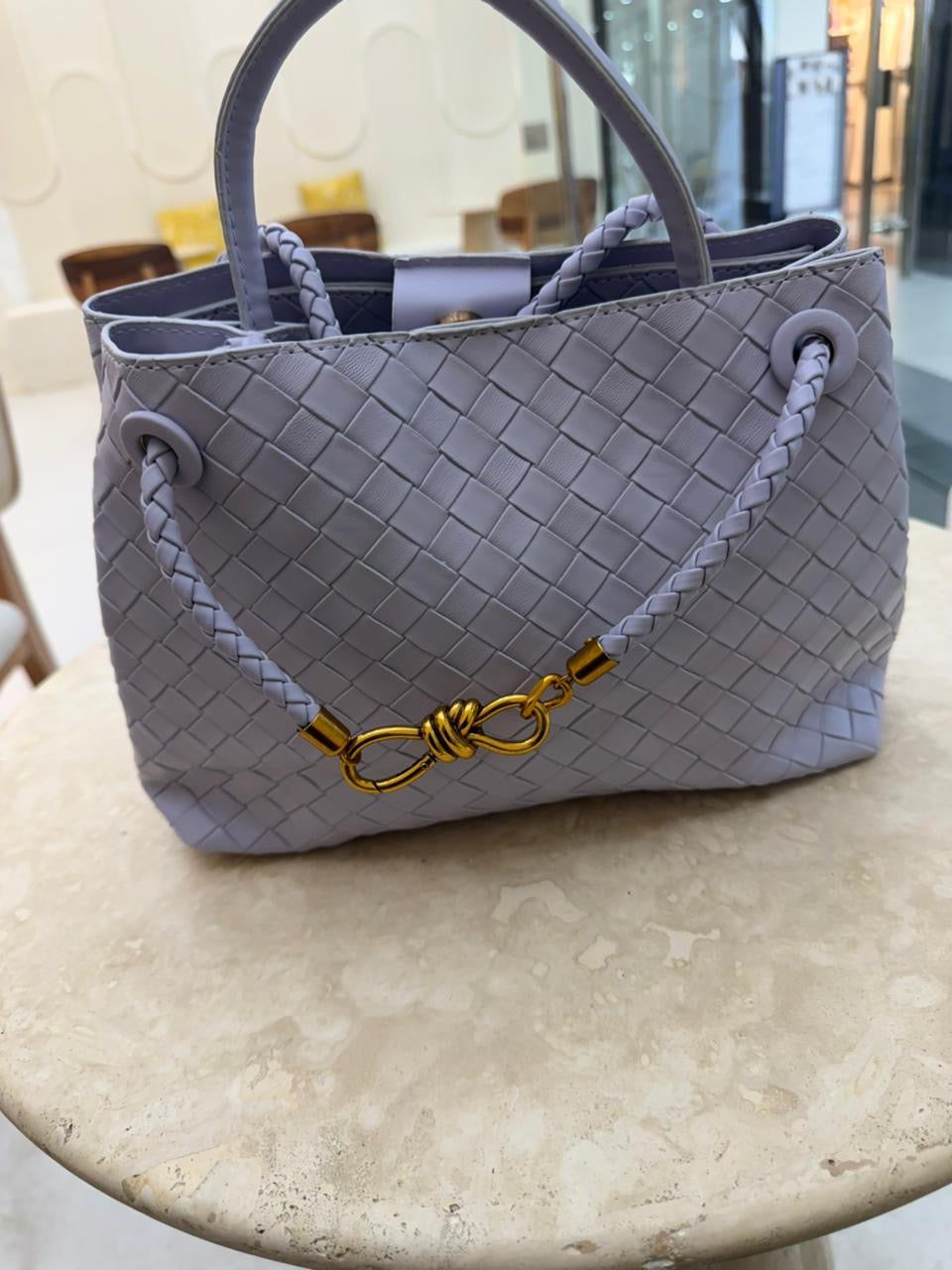 light purple Bottega Veneta Andiamo handbag features the brand's signature Intrecciato woven leather