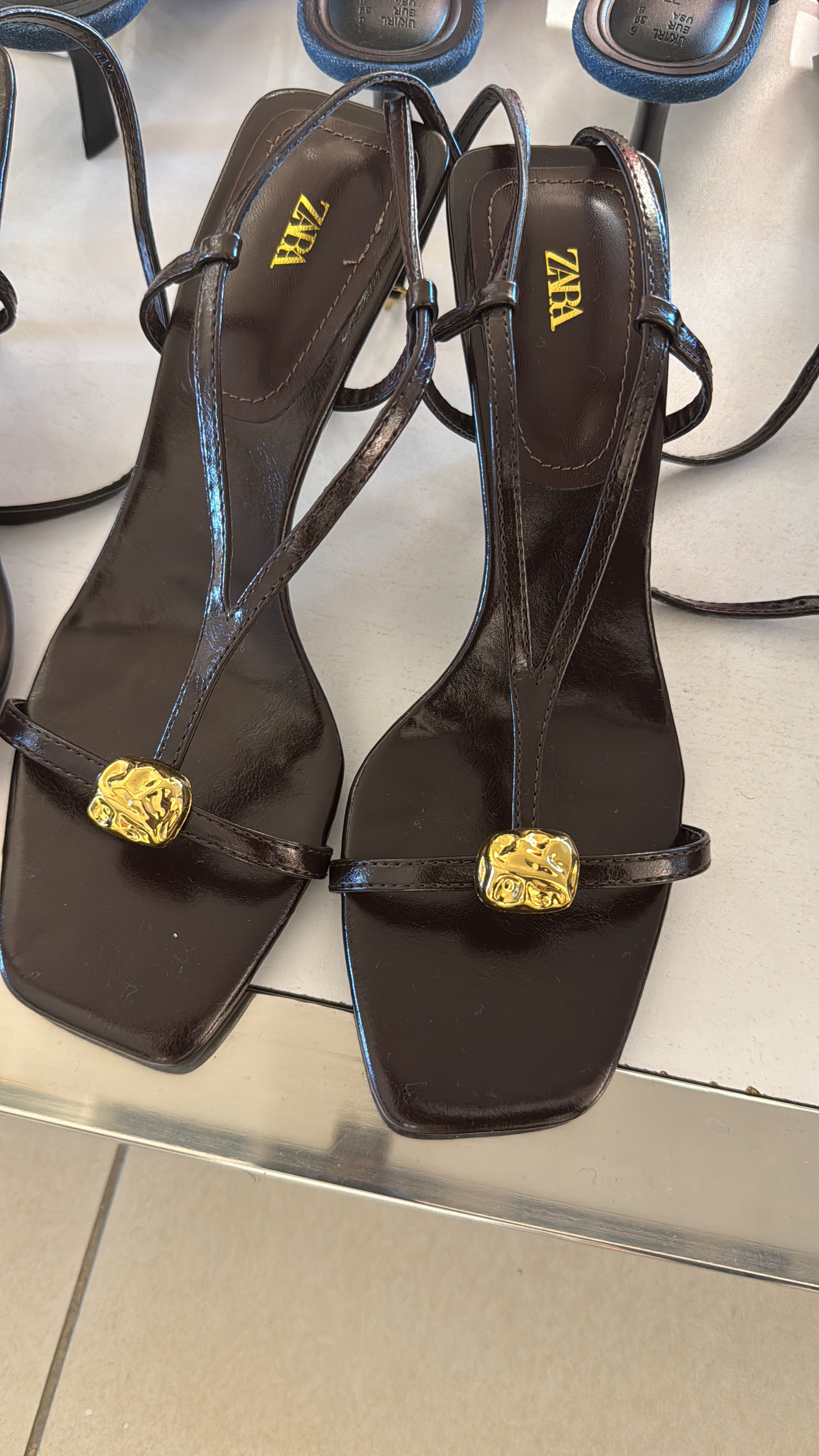Zara brown heels with a gold toned logo on the strap