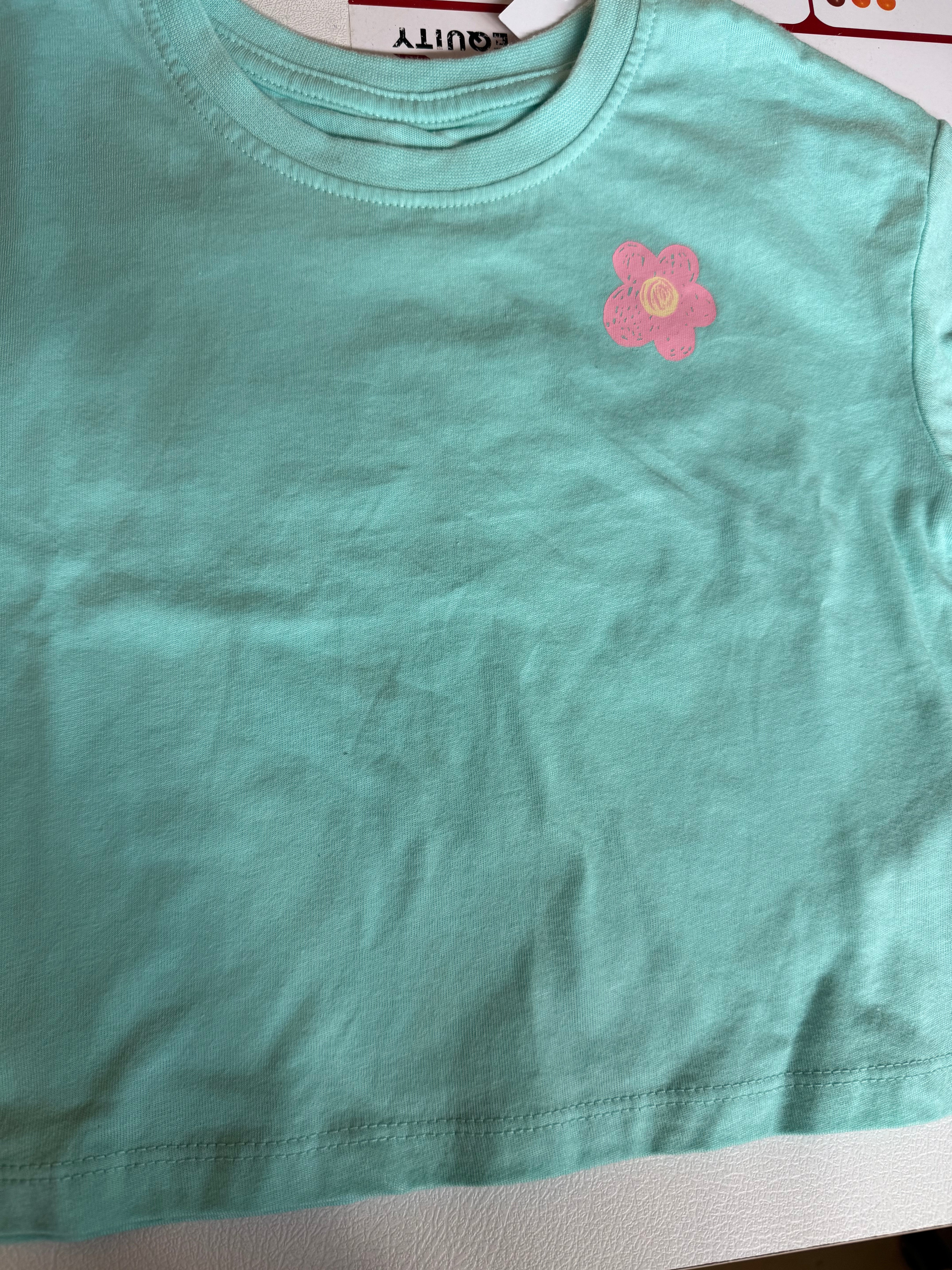 Primark care T-shirt with a daisy flower graphic on the chest
