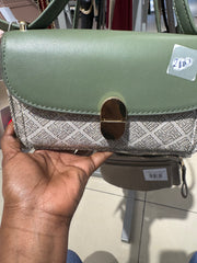 Patterned crossbody handbag with a gold tone turn lock closure