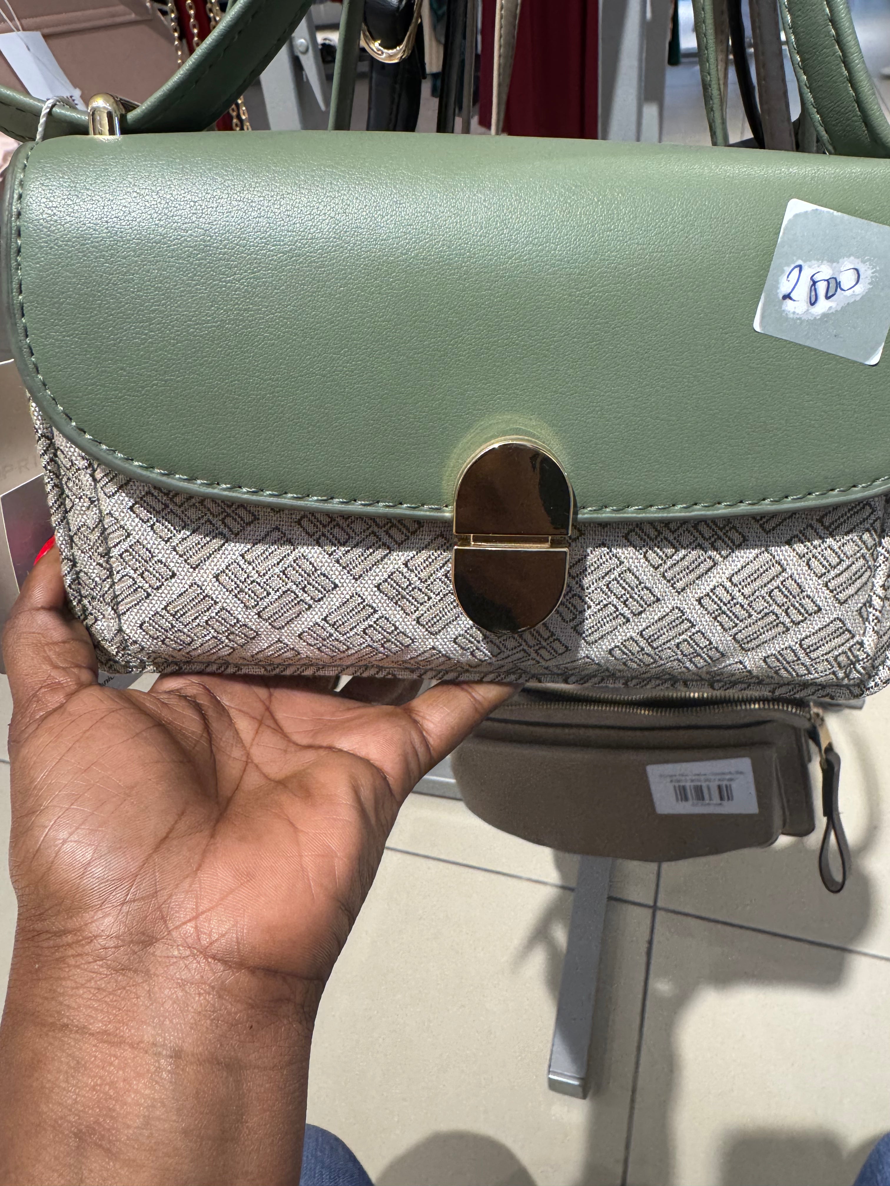 Patterned crossbody handbag with a gold tone turn lock closure