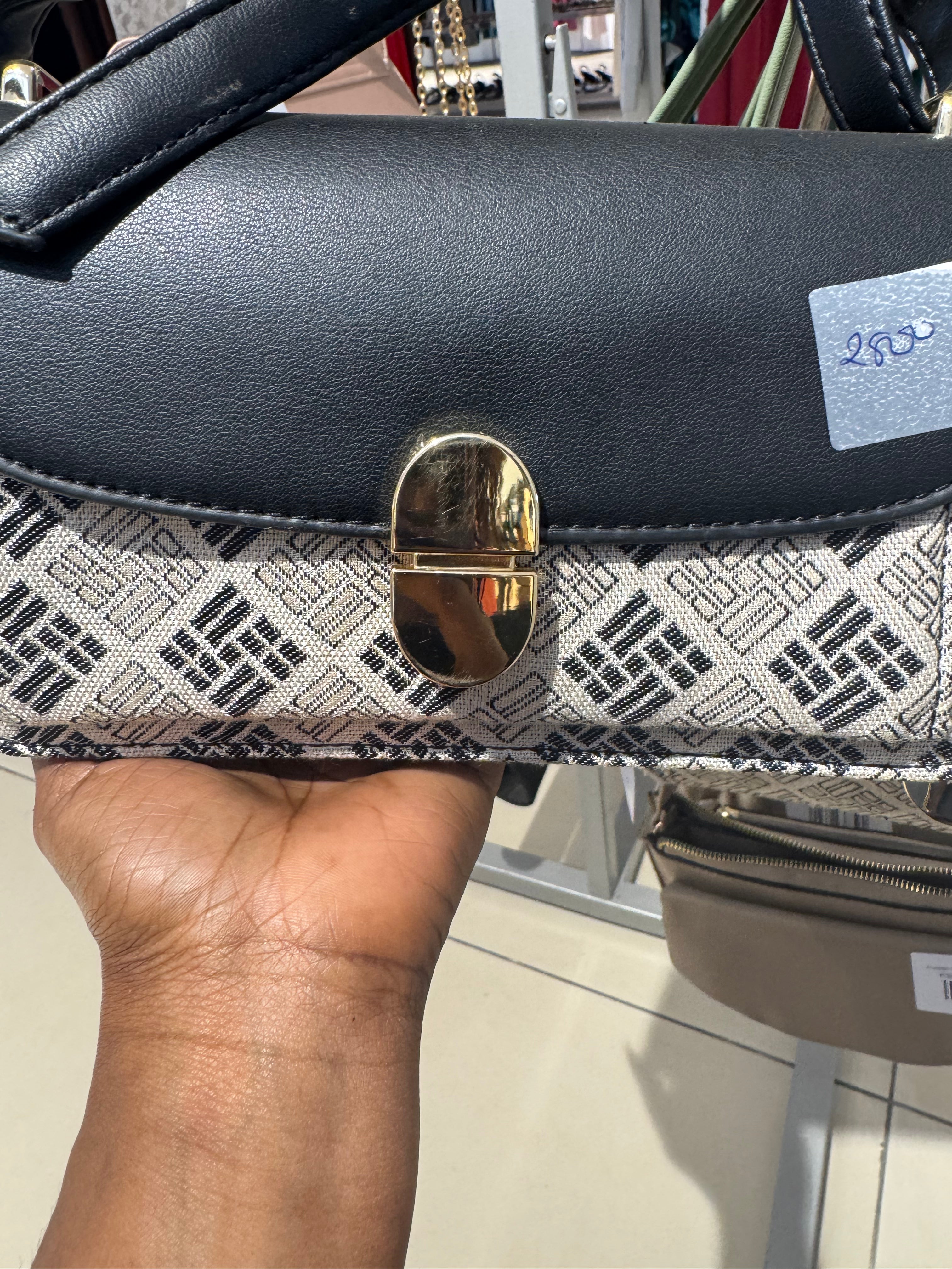 Patterned crossbody handbag with a gold tone turn lock closure