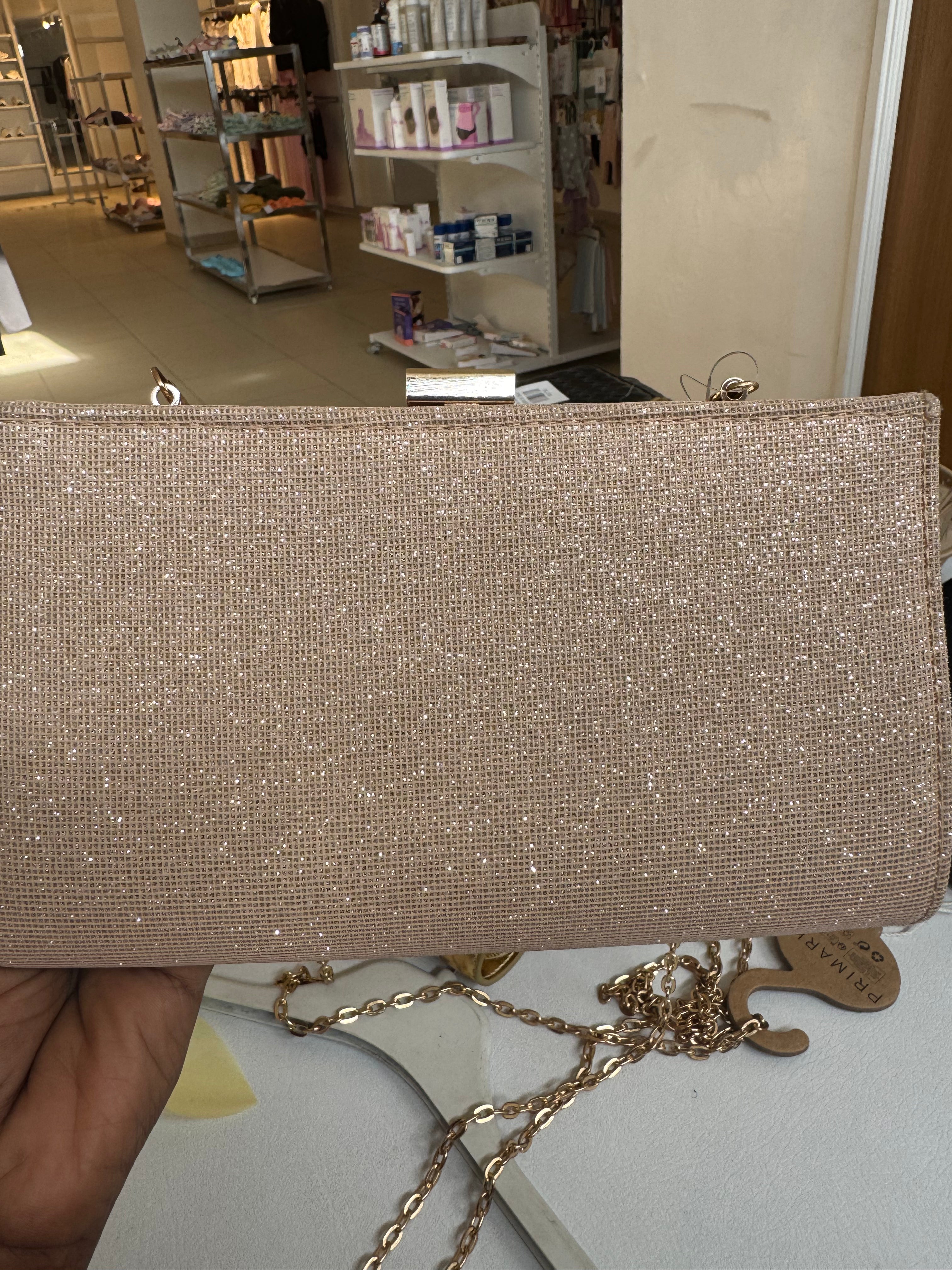 Rose gold coloured glitter clutch bag