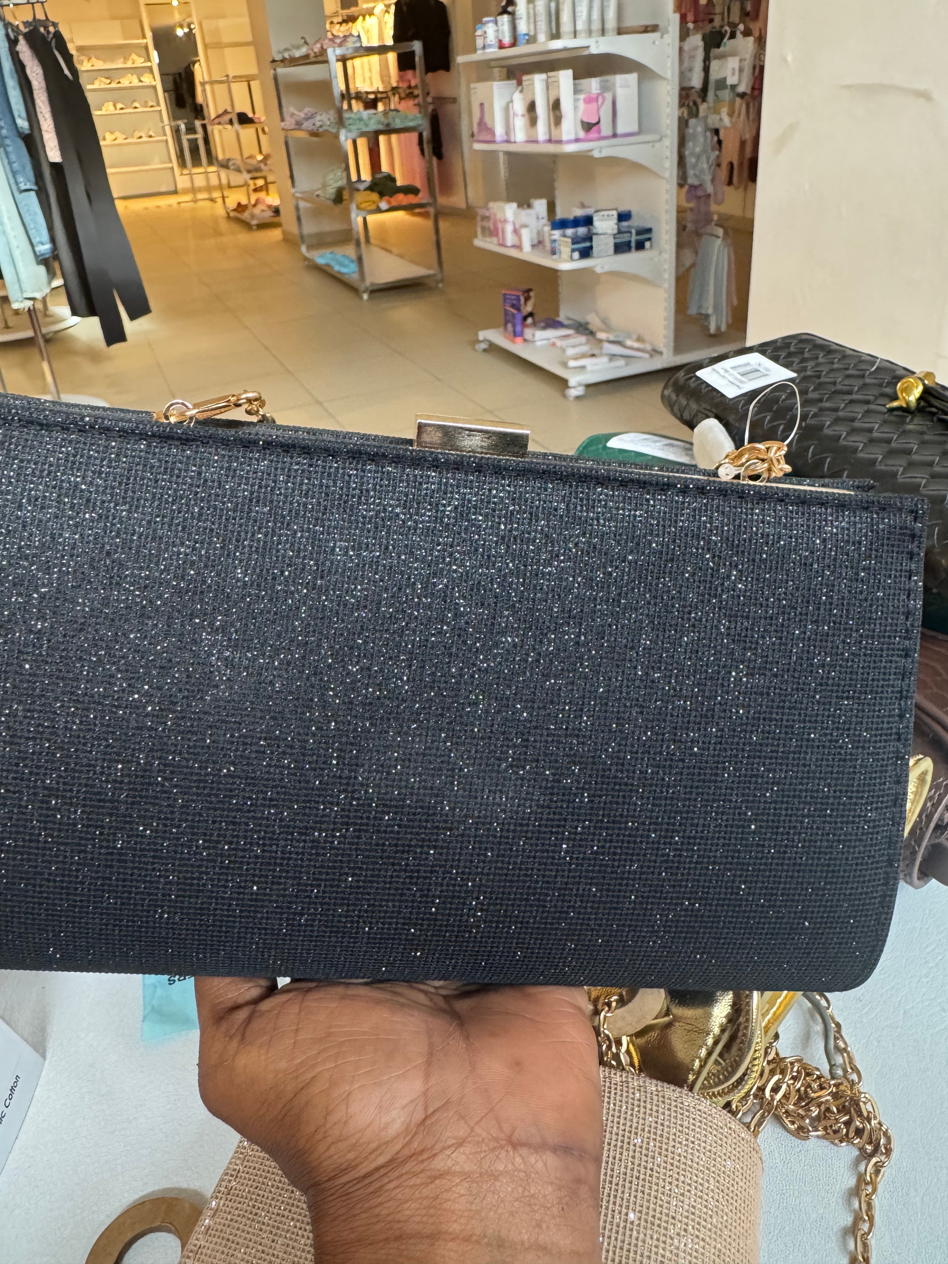 Rose gold coloured glitter clutch bag